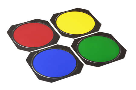 Four metal framed lighting color gel filters isolated on white