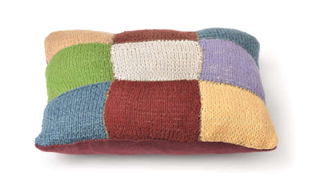 Colorful handmade knitted pillow isolated on white