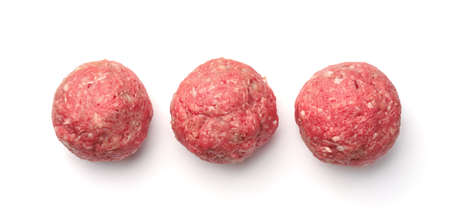 Top view of  three fresh raw homemade meatballs isolated on whiteの写真素材
