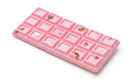 Pink craft chocolate bar with nuts isolated on whiteの写真素材