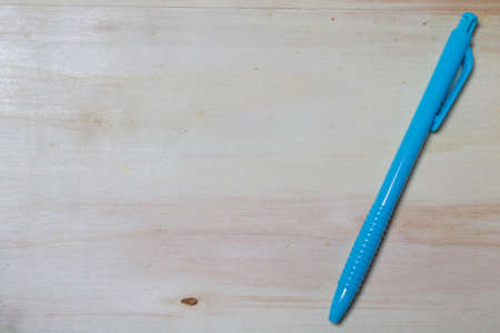 pen on wood backgroundの写真素材