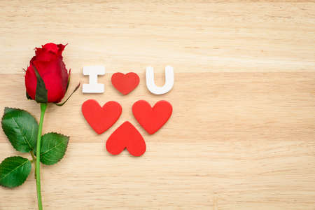 Valentine red roses and love heart on a wooden background.の写真素材