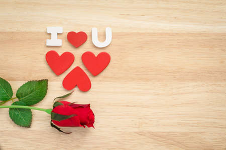 Valentine red roses and love heart on a wooden background.の写真素材