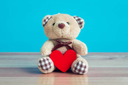 Valentine's Day  bear and heart on wooden background.の写真素材