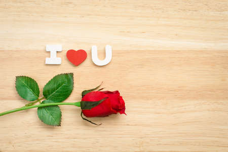 Valentine red roses and love heart on a wooden background.の写真素材