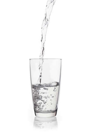 Water falling in glass on isolate background.の写真素材