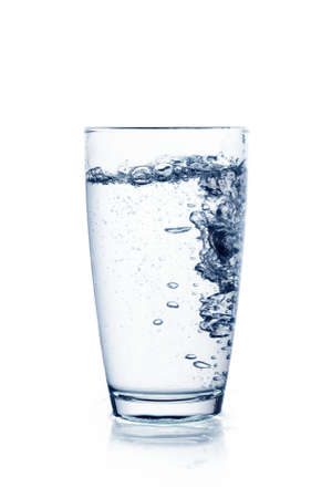 Water falling in glass on isolate background.の写真素材