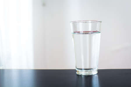 Glass of water on the table backgroundの写真素材