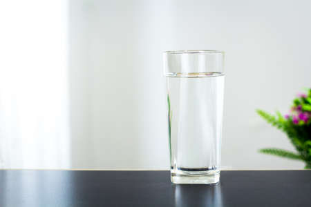 Glass of water on the table backgroundの写真素材
