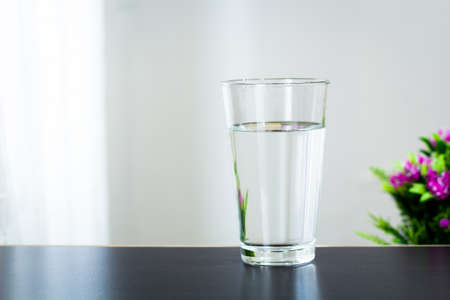Glass of water on the table backgroundの写真素材