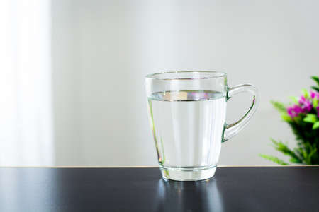 Glass of water on the table backgroundの写真素材