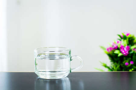 Glass of water on the table backgroundの写真素材