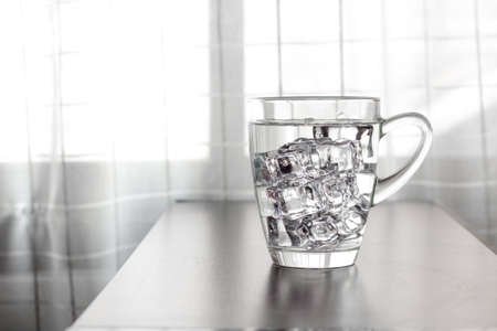 Glass of water on the table backgroundの写真素材