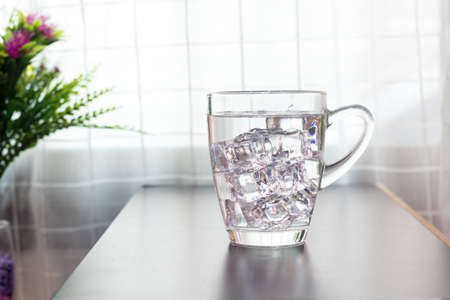 Glass of water on the table backgroundの写真素材