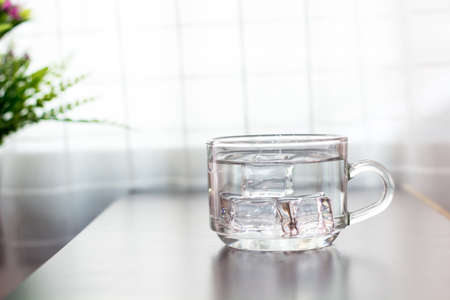 Glass of water on the table backgroundの写真素材