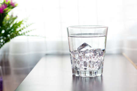 Glass of water on the table backgroundの写真素材