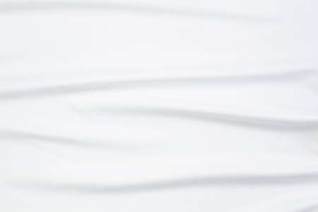 White fabric texture that is white cloth surface background with beautiful soft blur pattern.