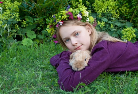 Girl with flower wreath and rabbitの写真素材
