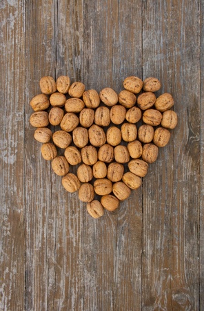 heart with walnuts o wooden groundの写真素材