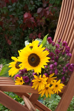 wooden chair with sunflowers の写真素材