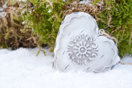 white heart in snowの写真素材