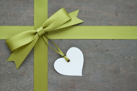 green loop with white heart on wooden ground green loop with white heart on wooden ground