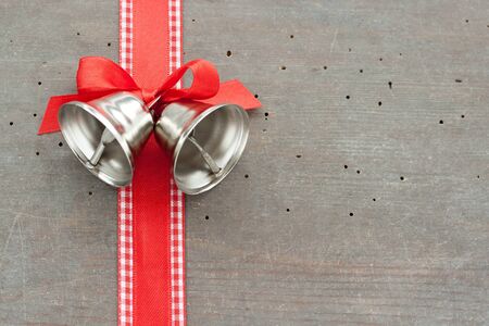 Bells and checked loop on wooden groundの写真素材