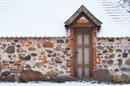 Old house of stone in winterの写真素材