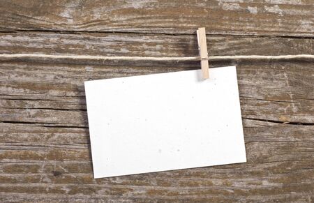 paper and close spin on wooden ground