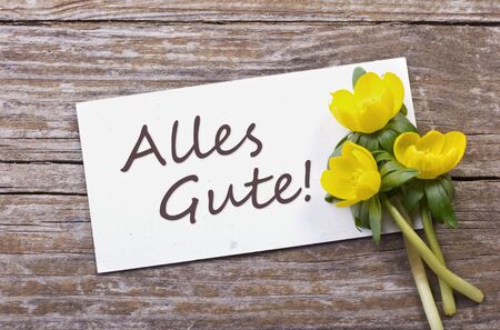 yellow blossoms and white card with  lettering all the bestの写真素材