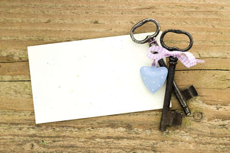 Two keys and heart on  boardの写真素材