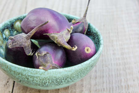 bowl with sharon fruits, courgettes, eggplantの写真素材