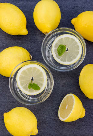 two glasses with water and lemons slicesの写真素材