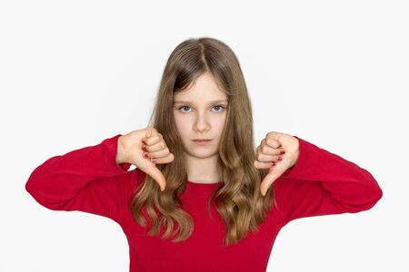 A girl with long hair showing the thumbs downの写真素材
