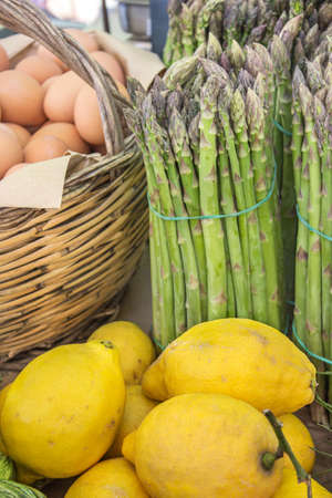 Display with green asparagus lemon and eggsの写真素材
