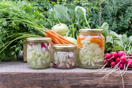Glasses with Lactic Acid pickled vegetables, fresh turnip, carrots and radishesの写真素材