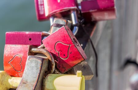 Padlocks with hearts on a bridge railingの写真素材