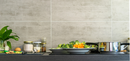 Kitchens with dishes, fresh vegetables and ingredients