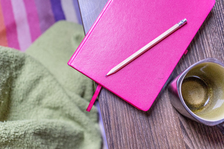 Pink notebook, pen and cupの写真素材