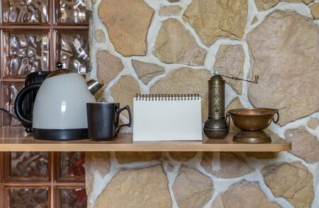 Kitchen still life with water cooker, cup and notepadの写真素材