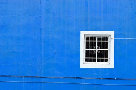 Blue facade with white windowの写真素材