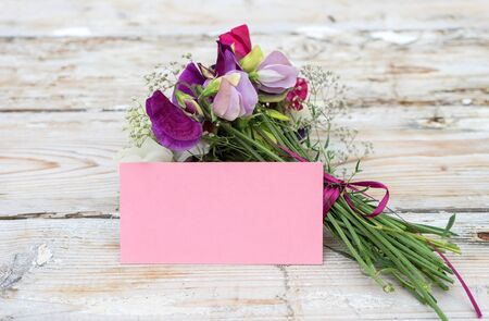 Bouquet of fragrant sweet peas and greeting cardの写真素材