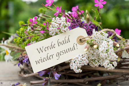 Greeting card with colorful bouquet and german text: Get better soonの写真素材