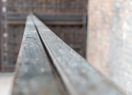 Old metal railing in the front of a wallの写真素材