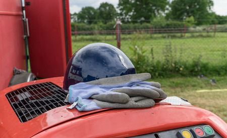 blue protective gloves and safety helmet on a fire engineの写真素材