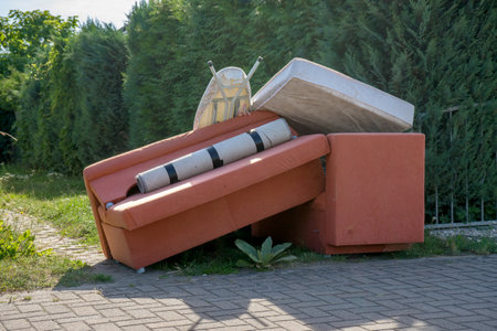 Bulky garbage heap at the roadside with upholstered furnitureの写真素材