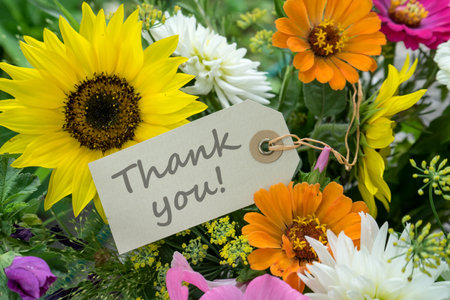 Colorful bouquet of summer flowers with card and english text: Thank you