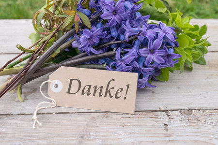 Bouquet of blue hyacinths and card with German text: Thank you