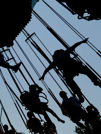 Man spreading arms on fun rideの写真素材