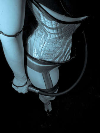 A woman in a corset and stockings in blue tonesの写真素材